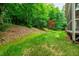 The spacious backyard features lush greenery and a vibrant Japanese Maple tree at 3908 Sterling Ridge Ln, Durham, NC 27707