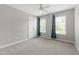 A spacious bedroom with a ceiling fan, plush carpeting, and natural light streaming through the windows at 3908 Sterling Ridge Ln, Durham, NC 27707