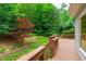 Wooden deck overlooking a lush, landscaped backyard, perfect for outdoor enjoyment and entertaining at 3908 Sterling Ridge Ln, Durham, NC 27707