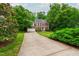Traditional brick home with a long driveway and lush green landscaping at 3908 Sterling Ridge Ln, Durham, NC 27707