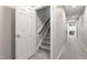 A well-lit hallway with stairs, and neutral tones, providing a welcoming transition between spaces in the home at 3908 Sterling Ridge Ln, Durham, NC 27707