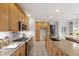 Gourmet kitchen featuring granite countertops, tile backsplash, stainless appliances, and a spacious island at 3908 Sterling Ridge Ln, Durham, NC 27707