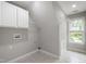 Convenient laundry area featuring tile floors, bright lighting, and ample storage for all your laundry needs at 3908 Sterling Ridge Ln, Durham, NC 27707