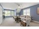 A bright living room features comfortable seating, soft lighting, and backyard views at 3908 Sterling Ridge Ln, Durham, NC 27707
