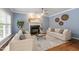 Inviting living room with a fireplace, large windows, neutral paint, and a decorative ceiling fan at 3908 Sterling Ridge Ln, Durham, NC 27707