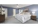 A spacious main bedroom features plush carpet, and ensuite bathroom, and soft lighting at 3908 Sterling Ridge Ln, Durham, NC 27707
