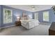 A tranquil main bedroom features plush carpet, ample natural light, and soothing blue walls at 3908 Sterling Ridge Ln, Durham, NC 27707