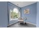 A cozy sitting room offers a unique arched window and comfortable seating at 3908 Sterling Ridge Ln, Durham, NC 27707