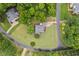 Beautiful aerial view of a home on a large, lush green lot with mature trees, perfectly landscaped at 3912 Kildrummy Dr, Durham, NC 27705