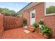 Charming brick patio is enhanced with various plants and flowerbeds at 3912 Kildrummy Dr, Durham, NC 27705
