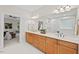 Bright bathroom featuring double sinks, updated vanity and a large mirror at 3912 Kildrummy Dr, Durham, NC 27705