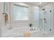 Soaking tub and glass shower create a spa-like primary bathroom at 3912 Kildrummy Dr, Durham, NC 27705