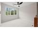 Spacious, light-filled bedroom with a ceiling fan and large window at 3912 Kildrummy Dr, Durham, NC 27705