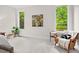 Bright bedroom featuring plush carpet, chair and plant near the window at 3912 Kildrummy Dr, Durham, NC 27705