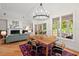 Dining room with hardwood flooring, fireplace, and large windows with backyard view at 3912 Kildrummy Dr, Durham, NC 27705