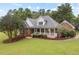 Inviting brick home with a well-manicured lawn and charming front porch at 3912 Kildrummy Dr, Durham, NC 27705