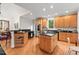 Open kitchen with granite countertops, stainless appliances, lots of storage and wooden cabinetry at 3912 Kildrummy Dr, Durham, NC 27705