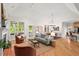 Spacious living room with hardwood floors, fireplace, and natural light at 3912 Kildrummy Dr, Durham, NC 27705