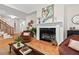 Open living space featuring a fireplace and staircase at 3912 Kildrummy Dr, Durham, NC 27705
