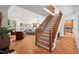 Bright, open living area with hardwood floors and a staircase at 3912 Kildrummy Dr, Durham, NC 27705
