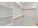 Well-organized walk-in closet featuring shelving and hanging rods at 3912 Kildrummy Dr, Durham, NC 27705