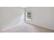 This bedroom offers neutral carpet and a window providing natural light at 407 Elm Farm Pl, Morrisville, NC 27560