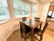Cozy dining area with a wooden table, four chairs, and a window for natural light at 407 Elm Farm Pl, Morrisville, NC 27560