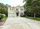 Charming two-story home featuring a garage and a beautifully patterned concrete driveway at 407 Elm Farm Pl, Morrisville, NC 27560