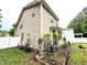 Home exterior featuring garden beds, lawn and irrigation system at 407 Elm Farm Pl, Morrisville, NC 27560