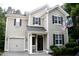 Two-story home featuring a garage and a basketball hoop at 407 Elm Farm Pl, Morrisville, NC 27560