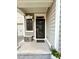 Inviting front porch with stylish furniture and a view of the garage at 407 Elm Farm Pl, Morrisville, NC 27560