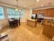 Bright kitchen with island, stainless steel appliances, and adjacent dining area at 407 Elm Farm Pl, Morrisville, NC 27560