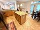 Bright kitchen featuring an island, stainless appliances, and view of the living room at 407 Elm Farm Pl, Morrisville, NC 27560
