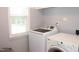 Functional laundry room with a washer and dryer and natural light from the window at 407 Elm Farm Pl, Morrisville, NC 27560