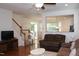 Inviting living room with hardwood floors, a ceiling fan, and an open view to the kitchen at 407 Elm Farm Pl, Morrisville, NC 27560