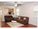 Bright living room featuring hardwood floors, ceiling fan, and comfortable couches at 407 Elm Farm Pl, Morrisville, NC 27560