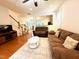 Spacious living room with hardwood floors and open access to kitchen and staircase at 407 Elm Farm Pl, Morrisville, NC 27560