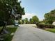 View of the neighborhood featuring driveways, landscaping, and plenty of trees at 407 Elm Farm Pl, Morrisville, NC 27560