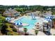 Aerial view of a community pool with a slide, lounge chairs, and umbrellas at 407 Elm Farm Pl, Morrisville, NC 27560