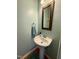 Pedestal sink with towel and mirror in a well lit area at 407 Elm Farm Pl, Morrisville, NC 27560