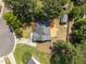 Aerial view of a single Gathering home featuring a large wooden deck surrounded by lush greenery at 408 Flagg Rd, Holly Springs, NC 27540