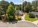 Aerial view of single Gathering home, driveway, and mature trees at 408 Flagg Rd, Holly Springs, NC 27540