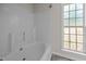 Bathroom featuring a bathtub and a window providing natural light at 408 Flagg Rd, Holly Springs, NC 27540