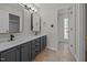 Bathroom featuring double sink vanity, modern fixtures, and tiled flooring at 408 Flagg Rd, Holly Springs, NC 27540