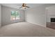Bright bedroom with plush carpeting, ceiling fan and a large window offering backyard views at 408 Flagg Rd, Holly Springs, NC 27540