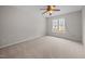 Spacious bedroom featuring neutral carpet, a ceiling fan, and a large window for natural light at 408 Flagg Rd, Holly Springs, NC 27540
