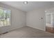 Carpeted bedroom features neutral walls and a window for natural light at 408 Flagg Rd, Holly Springs, NC 27540