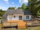 Aerial view of rear of home with a large wooden deck and back yard at 408 Flagg Rd, Holly Springs, NC 27540