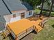 Aerial view of the home's rear exterior and expansive wooden deck at 408 Flagg Rd, Holly Springs, NC 27540