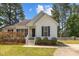 Charming one-story home with white siding, black shutters, and landscaped front yard at 408 Flagg Rd, Holly Springs, NC 27540